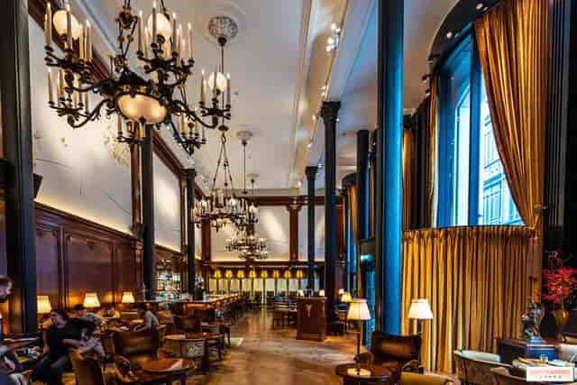 Elegant kitchen event space with chandeliers, perfect for networking and gatherings.