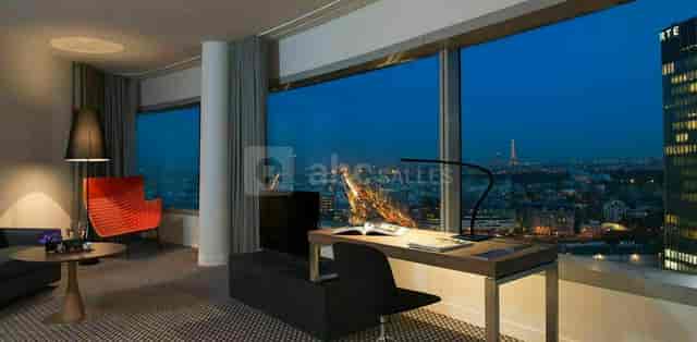 Cesar in stylish Meliá Paris La Défense room with Eiffel Tower view for business events.