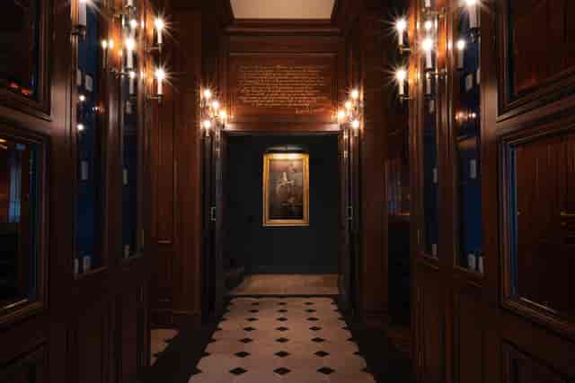 Elegant library hallway with warm wood paneling for events and receptions.