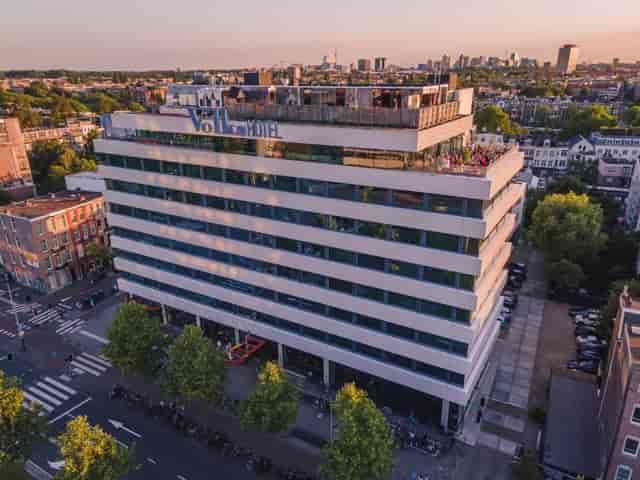 Modern Volkshotel with rooftop terrace, ideal for events and meetings in urban setting.