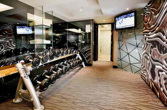 Modern fitness area with dumbbells in The Luxe Manor for wellness events.