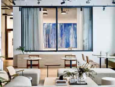 Modern meeting room with large windows, ideal for networking events and intimate meetings.