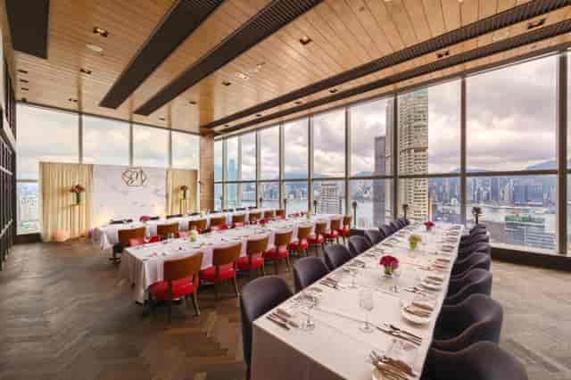 Sophisticated dining area with skyline views, perfect for upscale events and meetings.