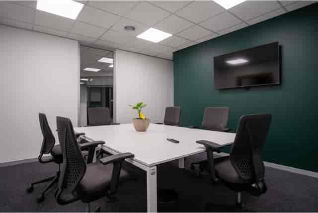 Modern boardroom with ergonomic chairs for collaborative meetings and presentations.