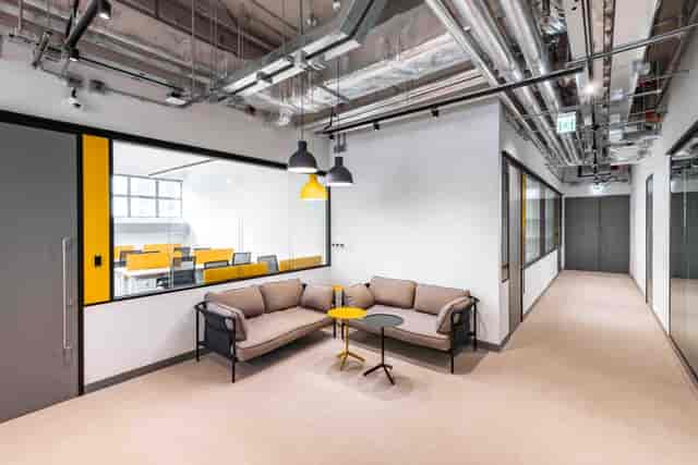 Modern coworking space with cozy seating, ideal for networking and meetings.