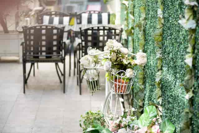 Corporate dinner party at Maison ES with elegant floral accents and lush greenery.