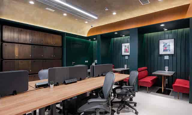 Modern co-working space with wooden desks, ideal for meetings and events.