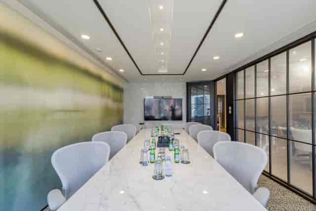 Modern conference room with marble table for high-level meetings and strategic planning.