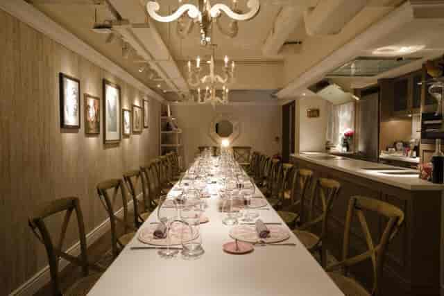 Elegant private dining room with long table, ideal for intimate gatherings and corporate dinners.