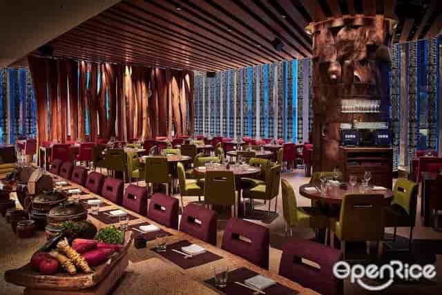 Modern Zuma restaurant interior with warm lighting, perfect for events and gatherings.