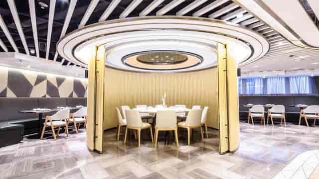 Modern meeting room with circular layout for intimate corporate events at Hotel COZi.