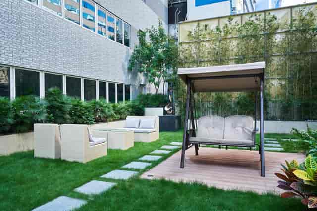 Serene outdoor meeting room with swing, ideal for networking events and casual meetings.