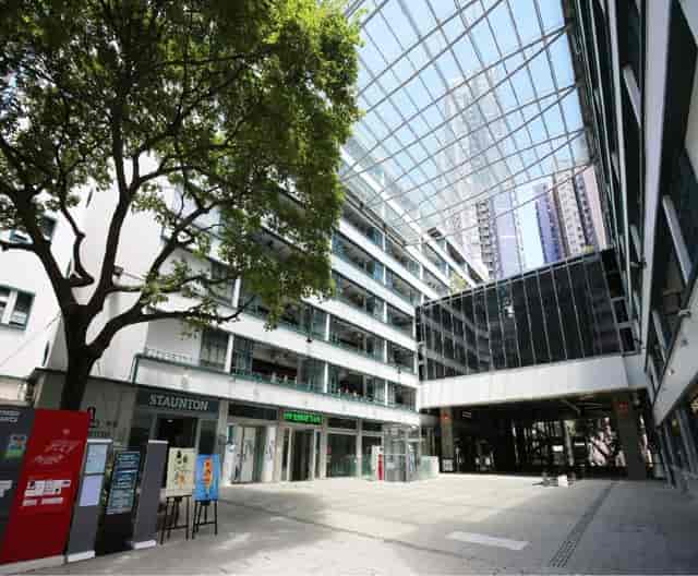 Modern open-air venue at PMQ with glass roof, perfect for networking events.
