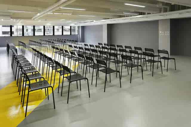 Event space with black chairs for a professional seminar in The Wave.