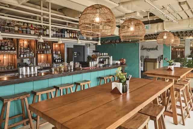 Stylish Limewood bar with wooden tables, ideal for social events and networking.