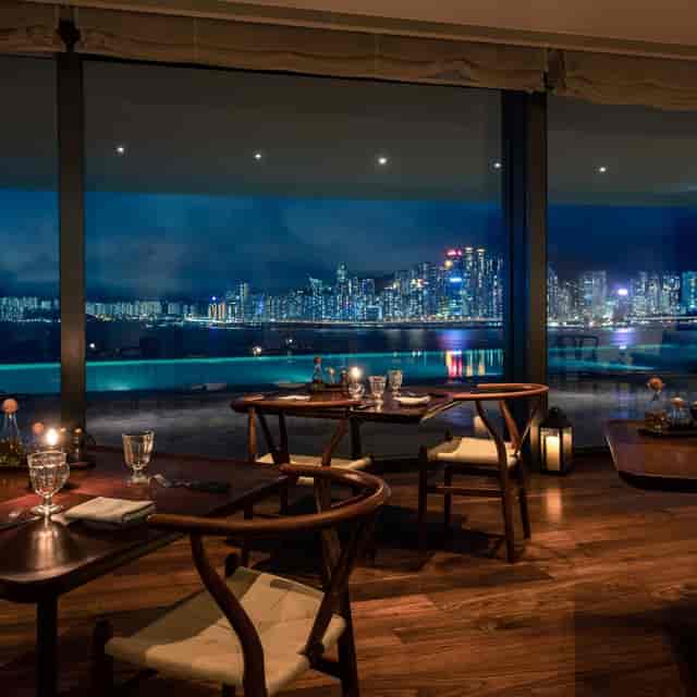 Elegant dining area in The Glasshouse with city skyline views for corporate events.