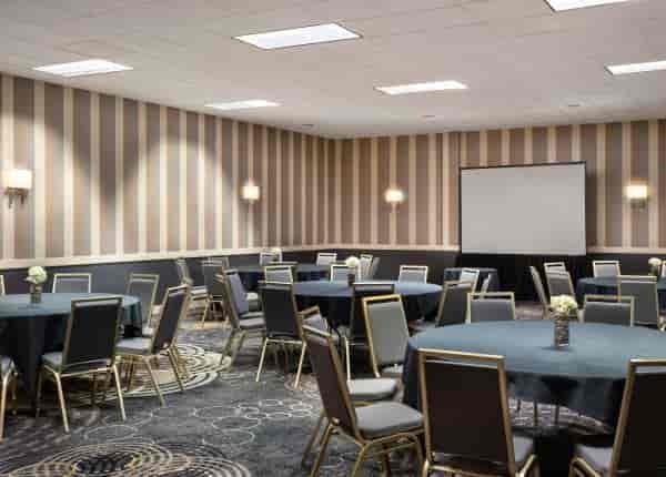 Conference Hall at Regal Hongkong Hotel with round tables, ideal for corporate events.