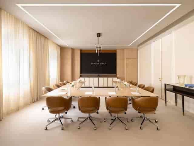 Modern conference room with wooden table, ideal for corporate events and meetings.