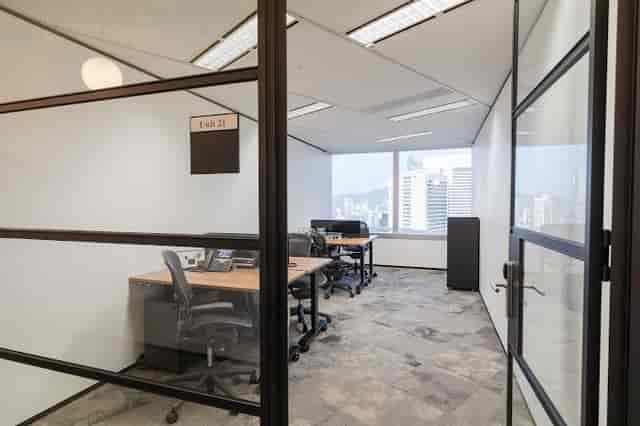 Modern private office meeting room with city view, ideal for collaborative sessions.
