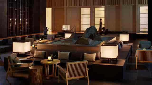 Boardroom lounge in Aman Tokyo, featuring ambient lighting for upscale networking events.