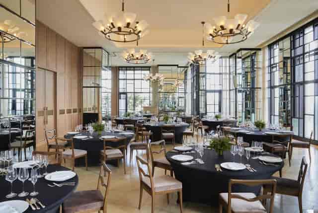 Elegant event space in Kimpton Shinjuku Tokyo with round tables and natural light.