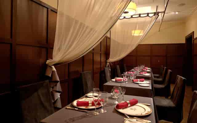 Elegant dining space with red accents for intimate meetings and private events.