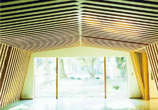 Modern Yayoi Auditorium with wooden beams, ideal for events and meetings.