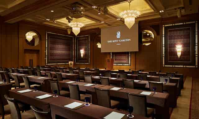 Ritz-Carlton Grand Ballroom set for a corporate event with elegant decor and seating.