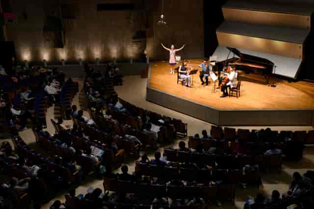 Main Hall Tokyo Bunka Kaikan concert performance with musicians and inviting stage setup.