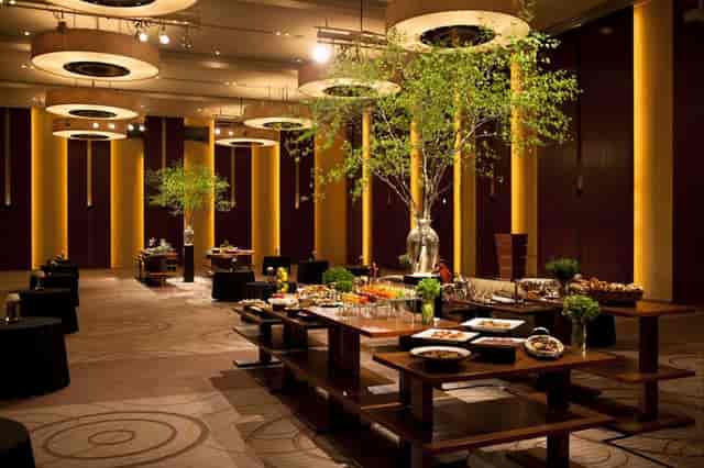 Elegant banquet hall in Conrad Tokyo with vibrant trees, perfect for upscale events.