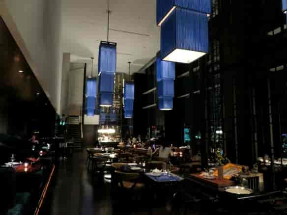 Sophisticated restaurant in Conrad Tokyo with elegant blue pendant lights for upscale events.