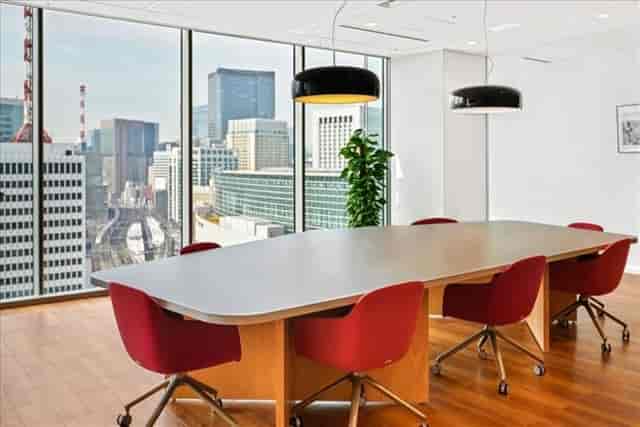 Modern conference room with skyline view, ideal for corporate meetings and events.