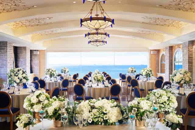 Elegant wedding venue at Sheraton Grande Tokyo Bay with floral centerpieces and stunning views.