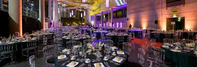 Elegant event setup in Reims Congress with black linens and fine dining for corporate gatherings.