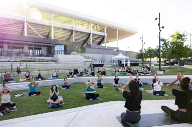 Outdoor yoga session at Live Oak Park, Q2 Stadium - wellness event, health retreat.
