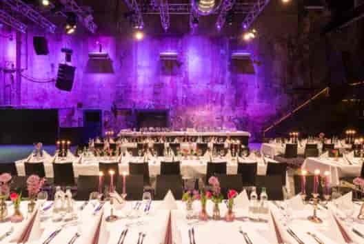 Elegant banquet space with purple lighting for corporate events at Palais Kulturbrauerei.