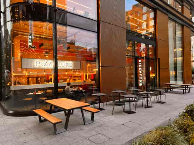 Modern dining venue with outdoor seating for casual meetings at PizzaLuxe Principal Place.