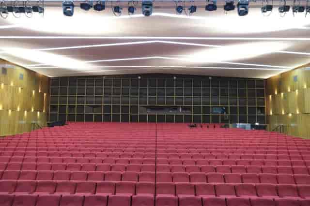 Einsteinsaal auditorium in Urania Berlin with tiered red seating for conferences and presentations.