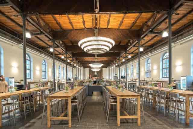 Spacious Bolle Meierei event venue with high ceilings, ideal for gatherings and meetings.