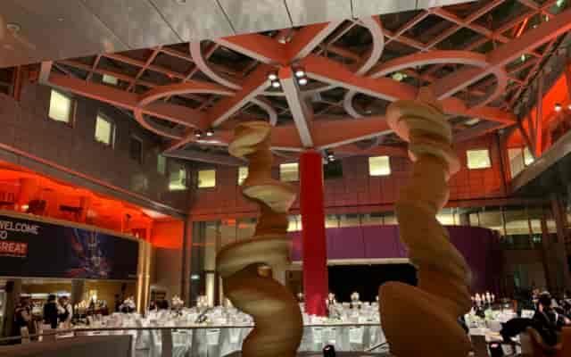 Elegant conference drum event space with spiral sculptures, perfect for corporate dinners.