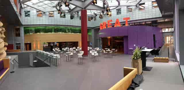 Modern event space in ARTrium with vibrant decor and "GREAT" signage for gatherings.