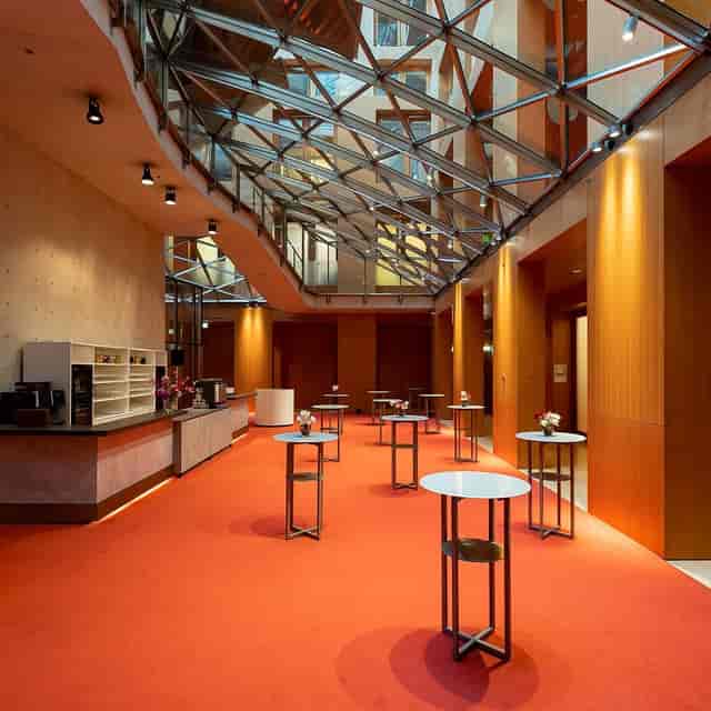 Modern event space in AXICA with high ceilings, ideal for networking and receptions.