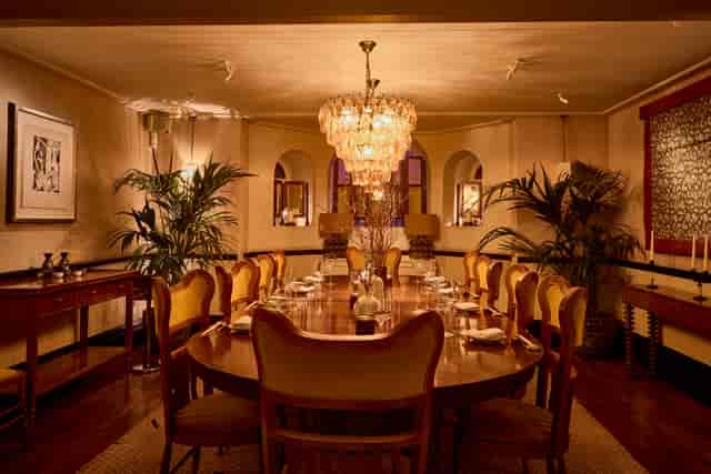 Elegant dining room for formal gatherings with plush chairs and warm chandelier lighting.