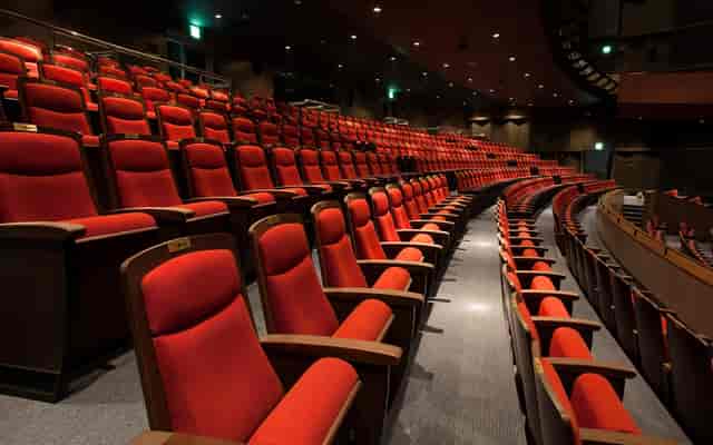 Woori Art Hall auditorium with red seating, ideal for conferences and performances.