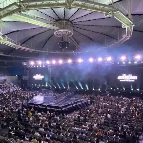 SK Handball Stadium stage set for concert, featuring dynamic lighting and spacious layout.
