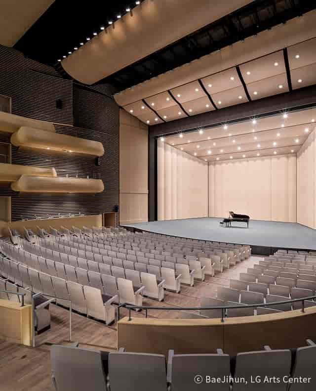 Modern auditorium with grand piano, perfect for concerts and corporate events.
