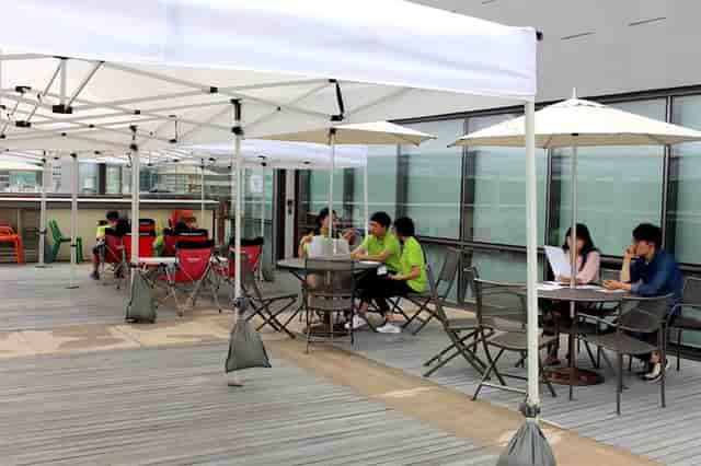 Outdoor meeting space with canopies for startup gatherings and brainstorming sessions.