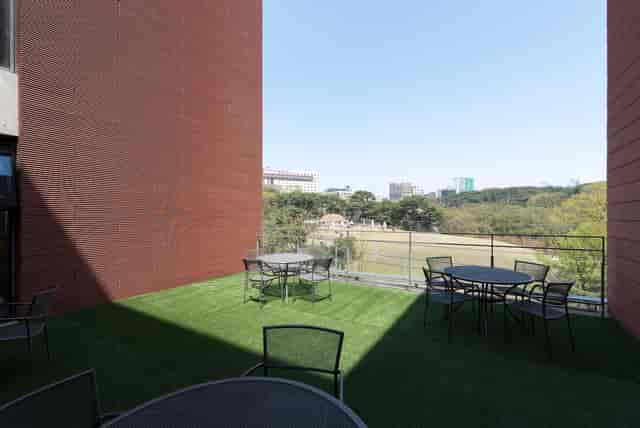 Spacious outdoor terrace at d·camp for networking events with urban backdrop.