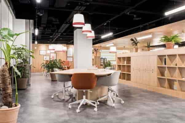Modern co-working space with round table for collaborative meetings and brainstorming.