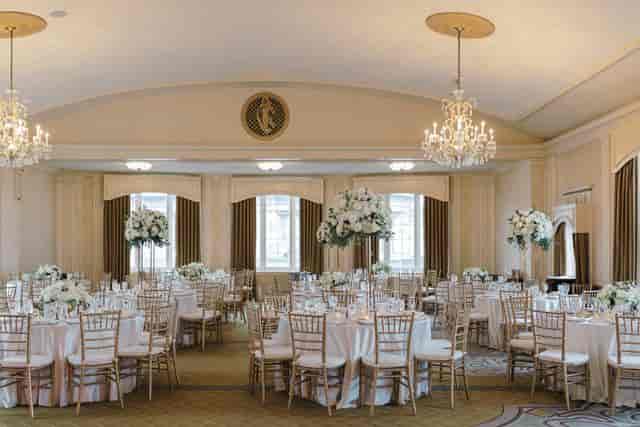 Rooftop Ballroom at Omni Parker House, elegant wedding venue with chandeliers and floral decor.